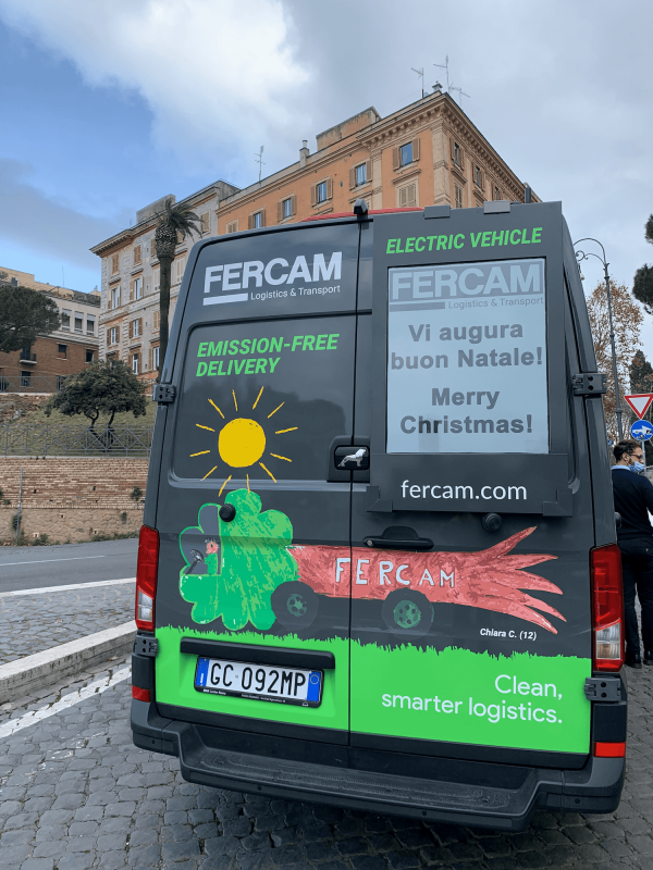 FERCAM's van with Truckscreenia screen wishing pedestrians merry Christmas